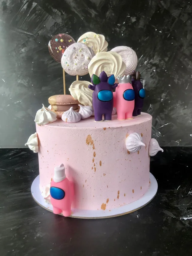 Among Us themed pink birthday cake with meringues