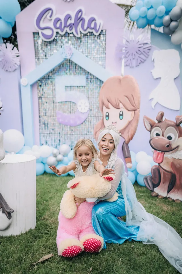 Elsa character hugging the birthday girl at a Frozen party in Bali
