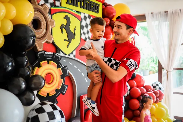 Racing-themed balloon decor with red and yellow garlands at a Bali party