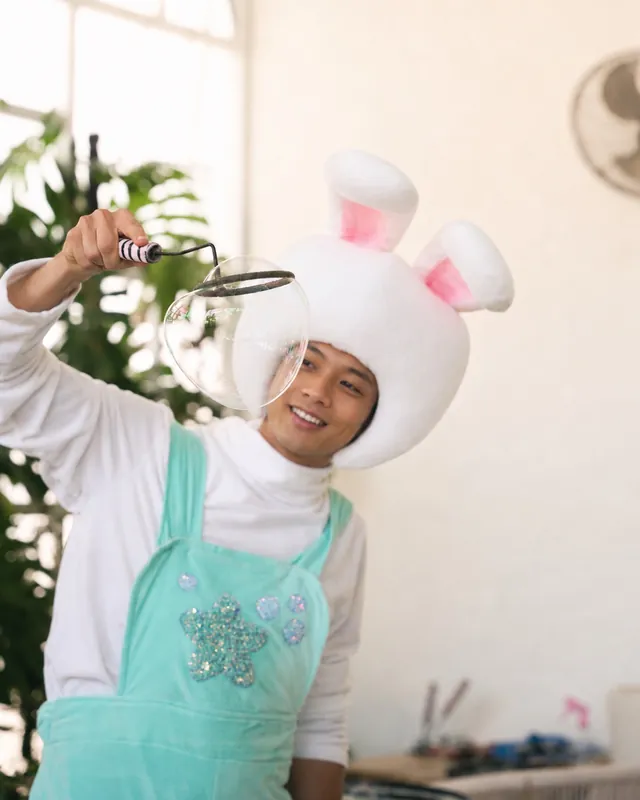 Bunny entertainer making a giant soap bubble at a kids party in Bali