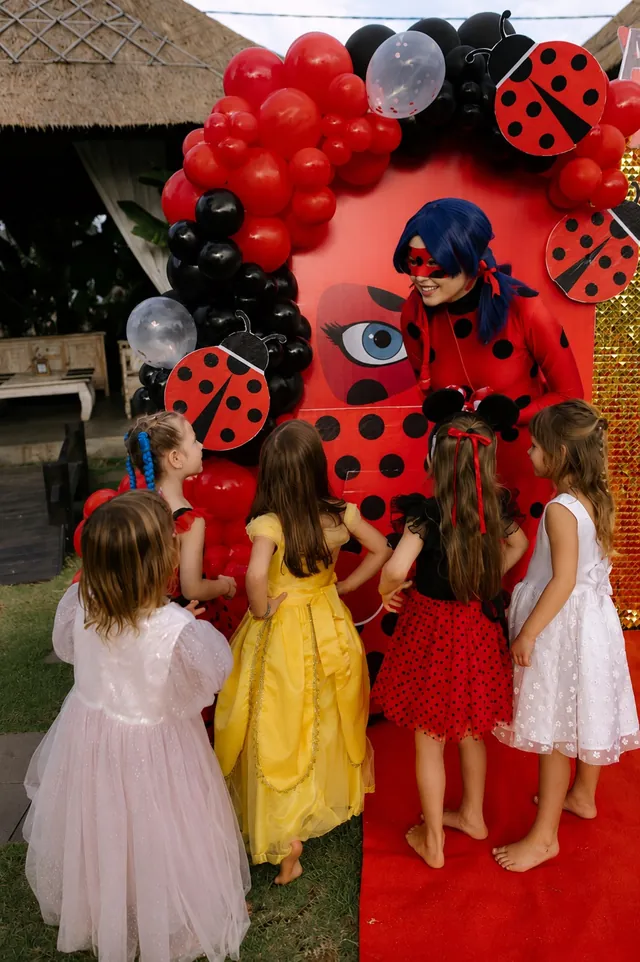 Ladybug character greeting kids at a themed party in Bali