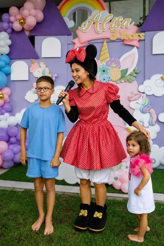 Minnie Mouse character with kids at a unicorn castle party in Bali