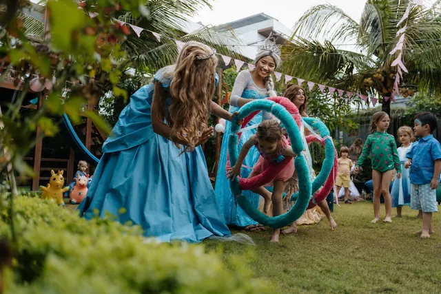 Princesses running party games with kids at a Bali birthday