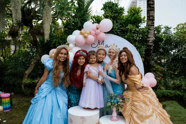 Princess characters posing with the birthday girl at a Bali party
