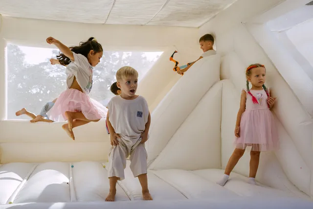 Kids jumping inside a bounce castle at a Bali party