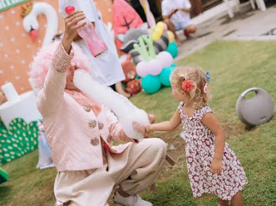 Party entertainer showing bubble tricks to a toddler at a Bali party
