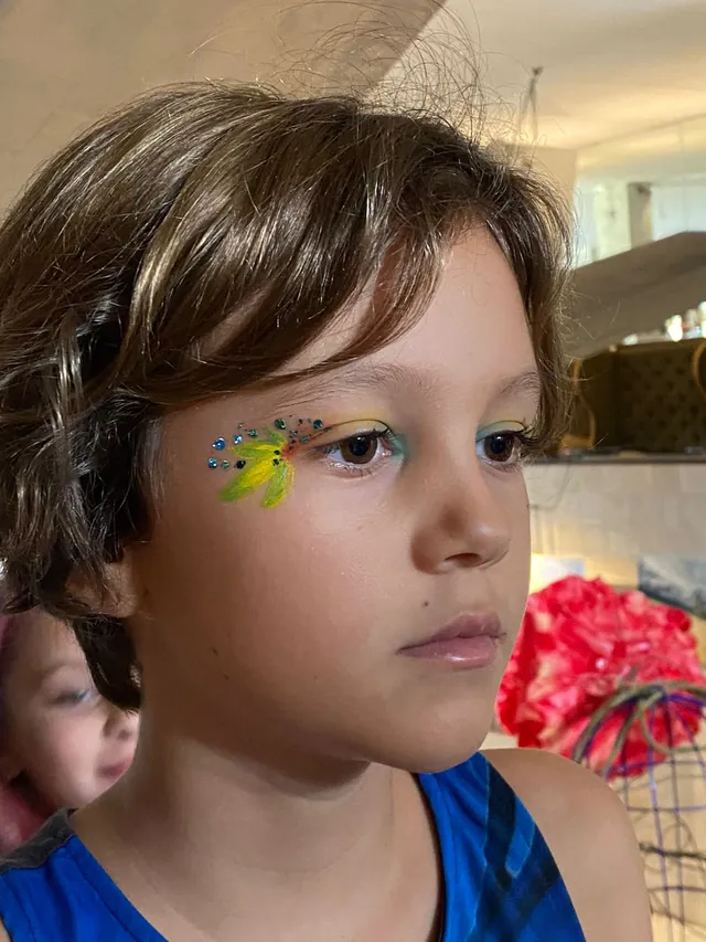 Boy with festive face paint art at a Bali birthday party