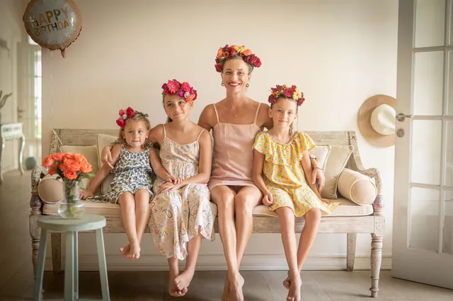 Family wearing handmade flower crowns at a Bali party