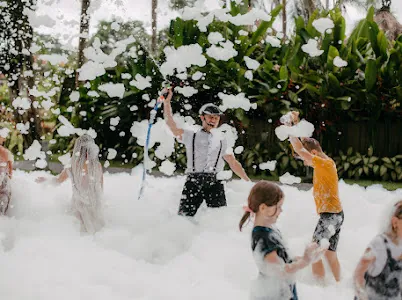 Kids in a foam battle at a birthday party in Bali