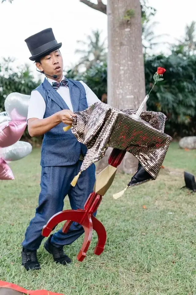 Magician performing a levitating table trick at a Bali kids party