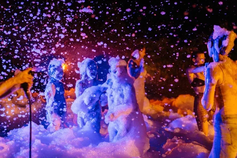 Colourful neon foam party in a Bali garden at night