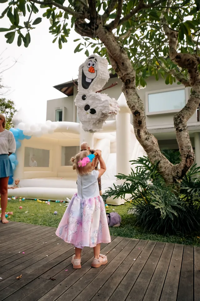 Kids taking turns at the Olaf pinata at a Bali birthday party