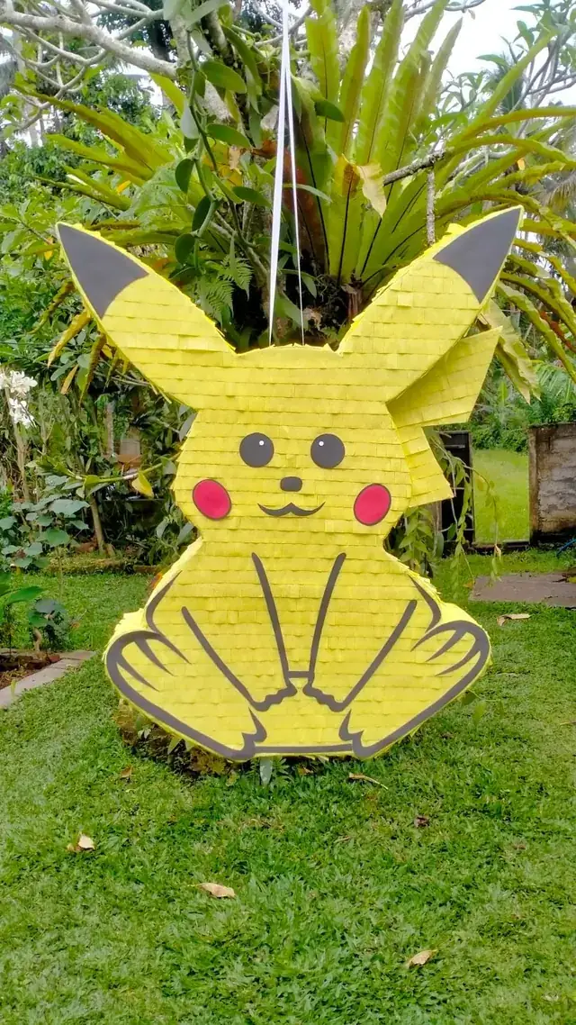 Pikachu pinata hanging in a tropical garden in Bali
