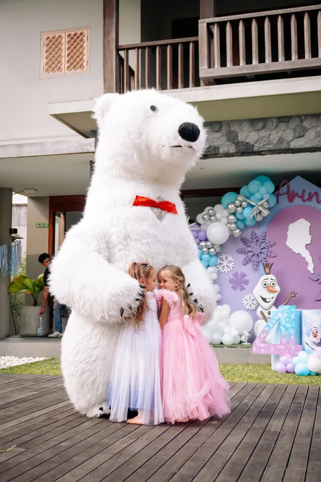 Giant polar bear mascot hugging girls at a Frozen party in Bali