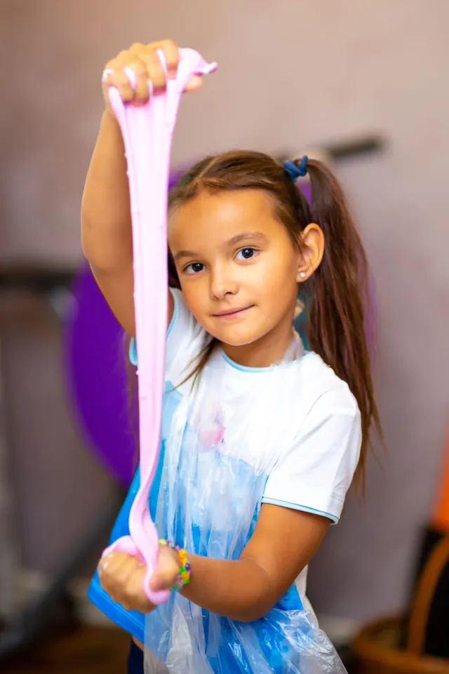 Girl showing off her pink slime at a Bali slime master class