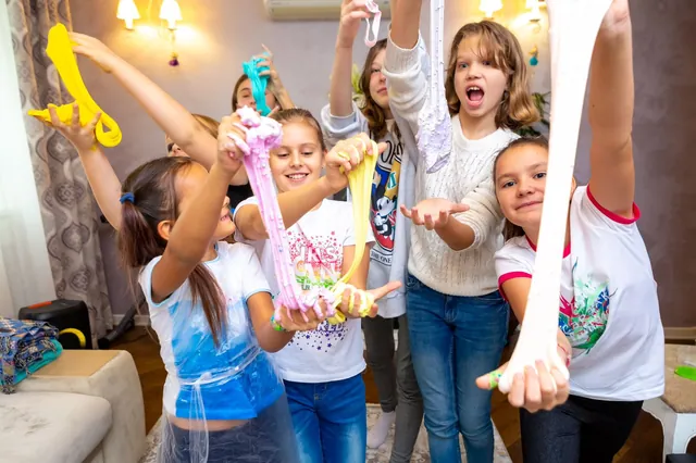 Kids stretching colourful slime at a workshop in Bali