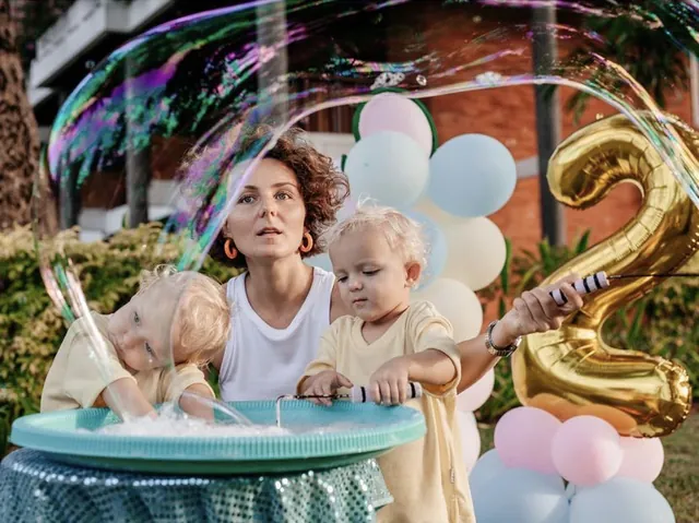 Toddler playing at the bubble table on his second birthday in Bali